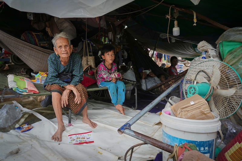 Cambodian villagers sit under a tent at resettlement camp in Wat Phnom Kamboar, Oddar Meanchey province, Cambodia, July 29, 2025.
