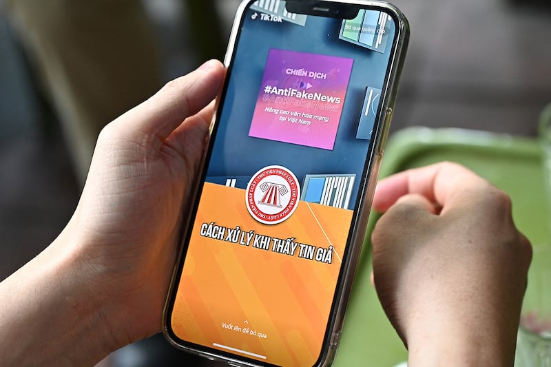 A man watches a video on misinformation on the social media platform TikTok in Hanoi on Oct. 6, 2023.