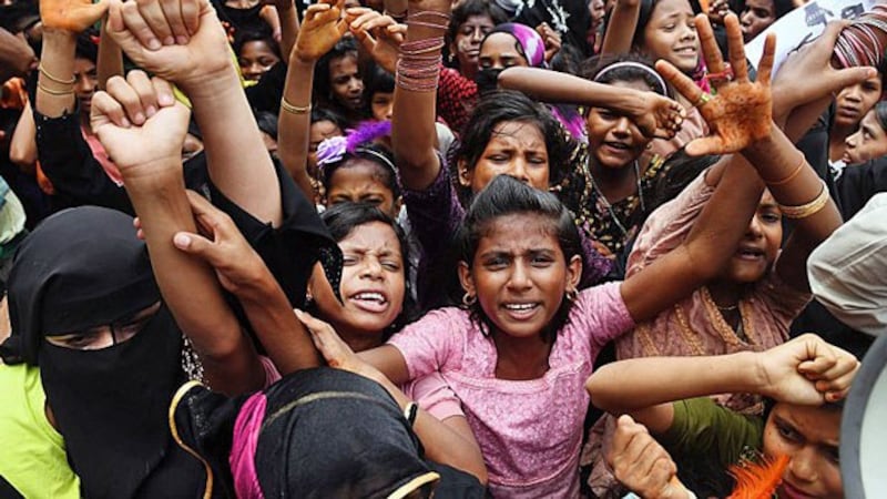 Rohingya refugees shout slogans during a protest march marking the first anniversary of a Myanmar military crackdown that sparked a massive exodus to camps in Bangladesh, at the Kutupalong refugee camp in Ukhia subdistrict, southeastern Bangladesh's Cox's Bazar, Aug. 25, 2018.