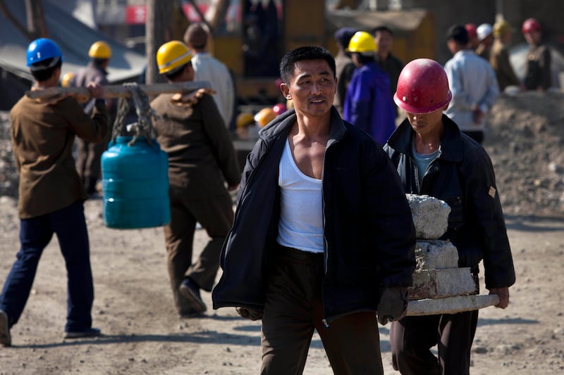 In this Oct. 11, 2011, photo, North Korean construction workers carry material in the Mansudae area of Pyongyang, North Korea.