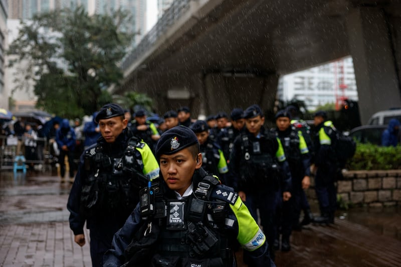 Police patrol outside the West Kowloon Magistrates' Courts building as Jimmy Lai, the founder of the now-defunct pro-democracy newspaper Apple Daily, takes the witness stand for the first time in the national security collusion trial, in Hong Kong, China, Nov. 20, 2024.